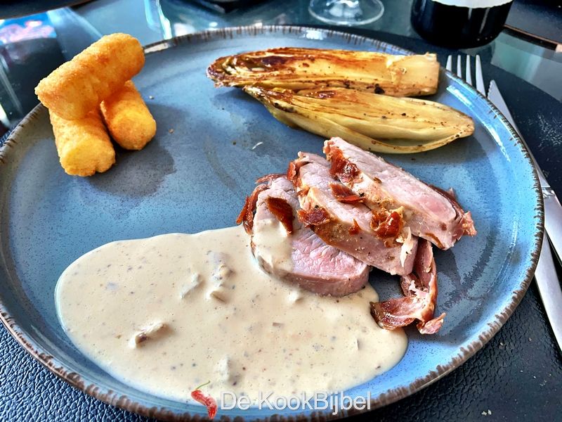 Pork tenderloin with grain mustard sauce and braised chicory